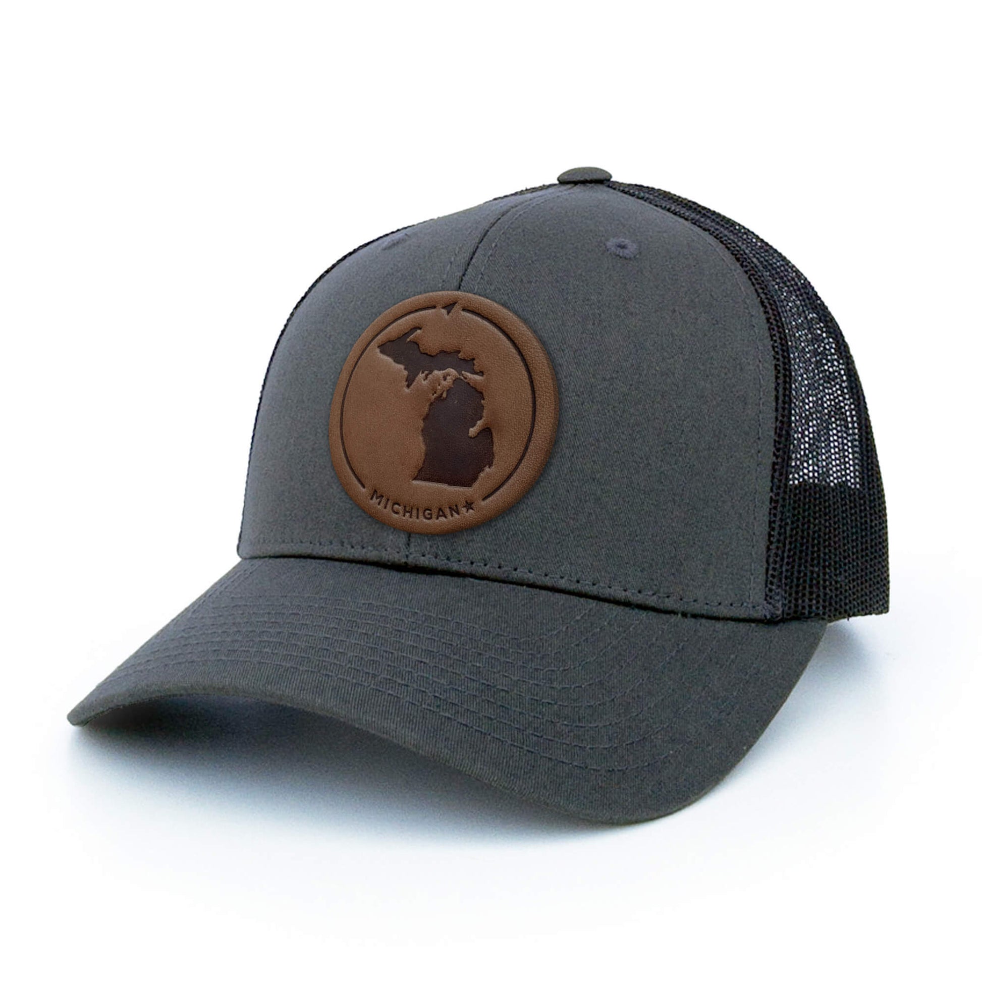 Charcoal trucker hat with full-grain leather patch of a Michigan | BLACK-003-007, CHARC-003-007, NAVY-003-007, HGREY-003-007, MOSS-003-007, BROWN-003-007