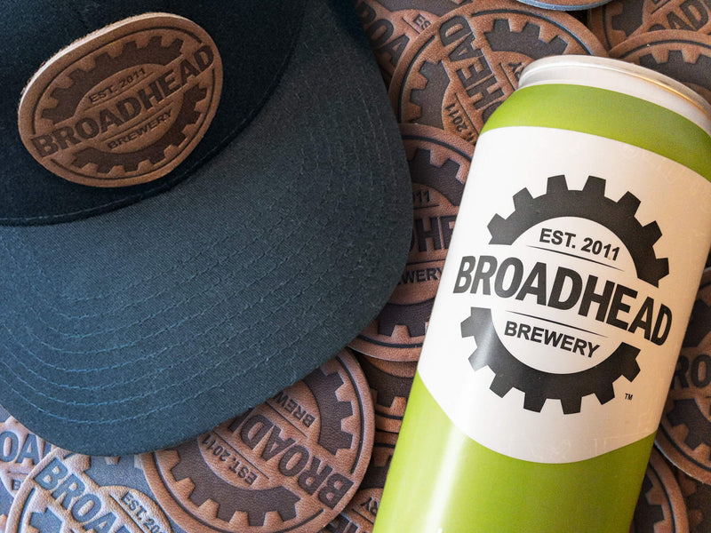 Stack of leather patches and leather patch hat with heat-stamped logo for Broadhead Beer