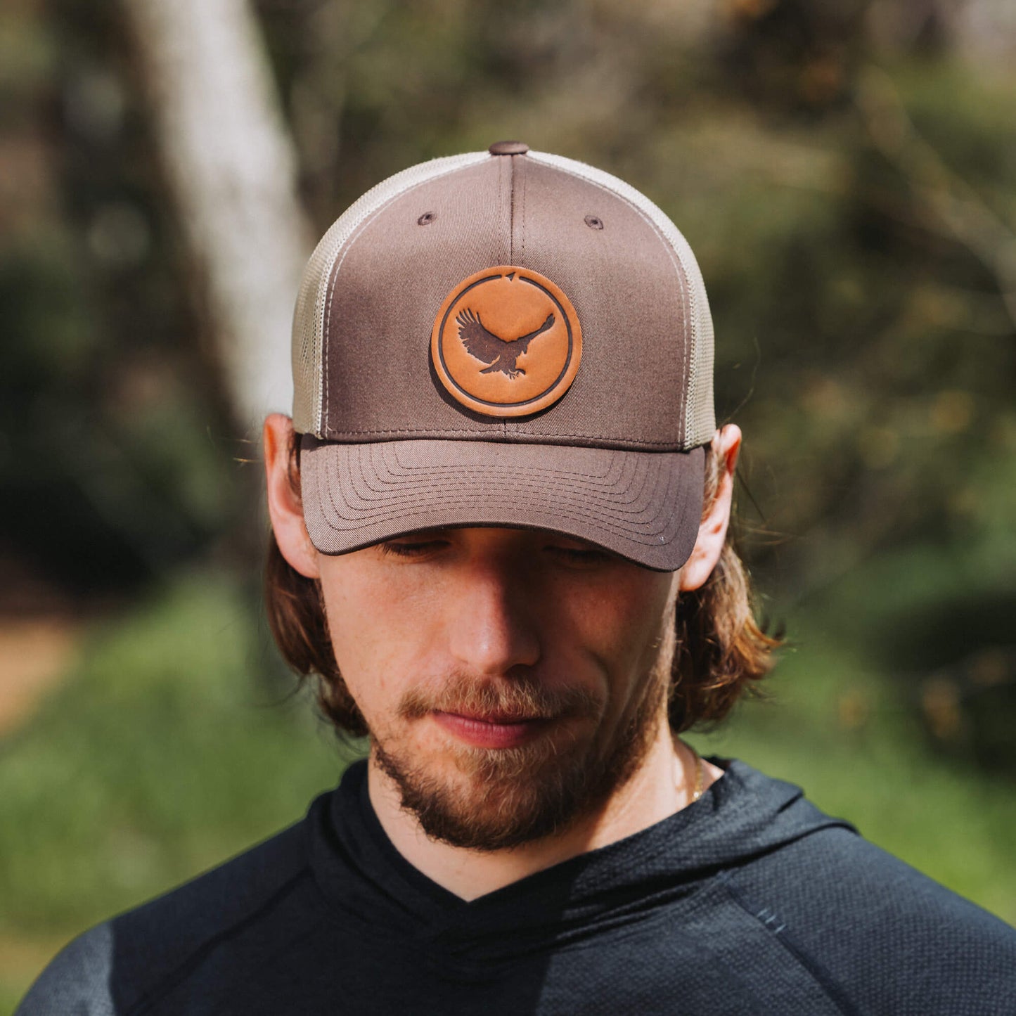 Brown and khaki trucker hat with full-grain leather patch of an Eagle | BLACK-004-004, CHARC-004-004, NAVY-004-004, HGREY-004-004, MOSS-004-004, BROWN-004-004