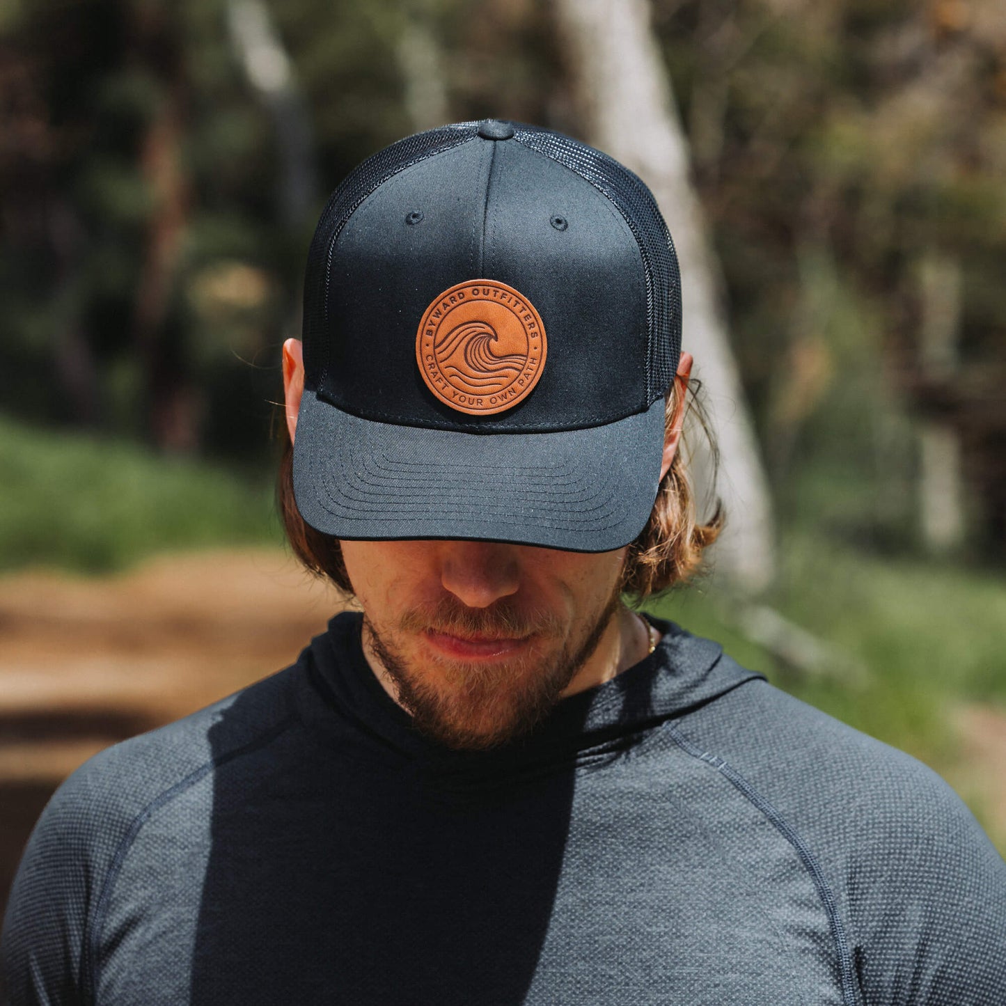 Black trucker hat with full-grain leather patch of a Rolling Wave | BLACK-005-003, CHARC-005-003, NAVY-005-003, HGREY-005-003, MOSS-005-003, BROWN-005-003